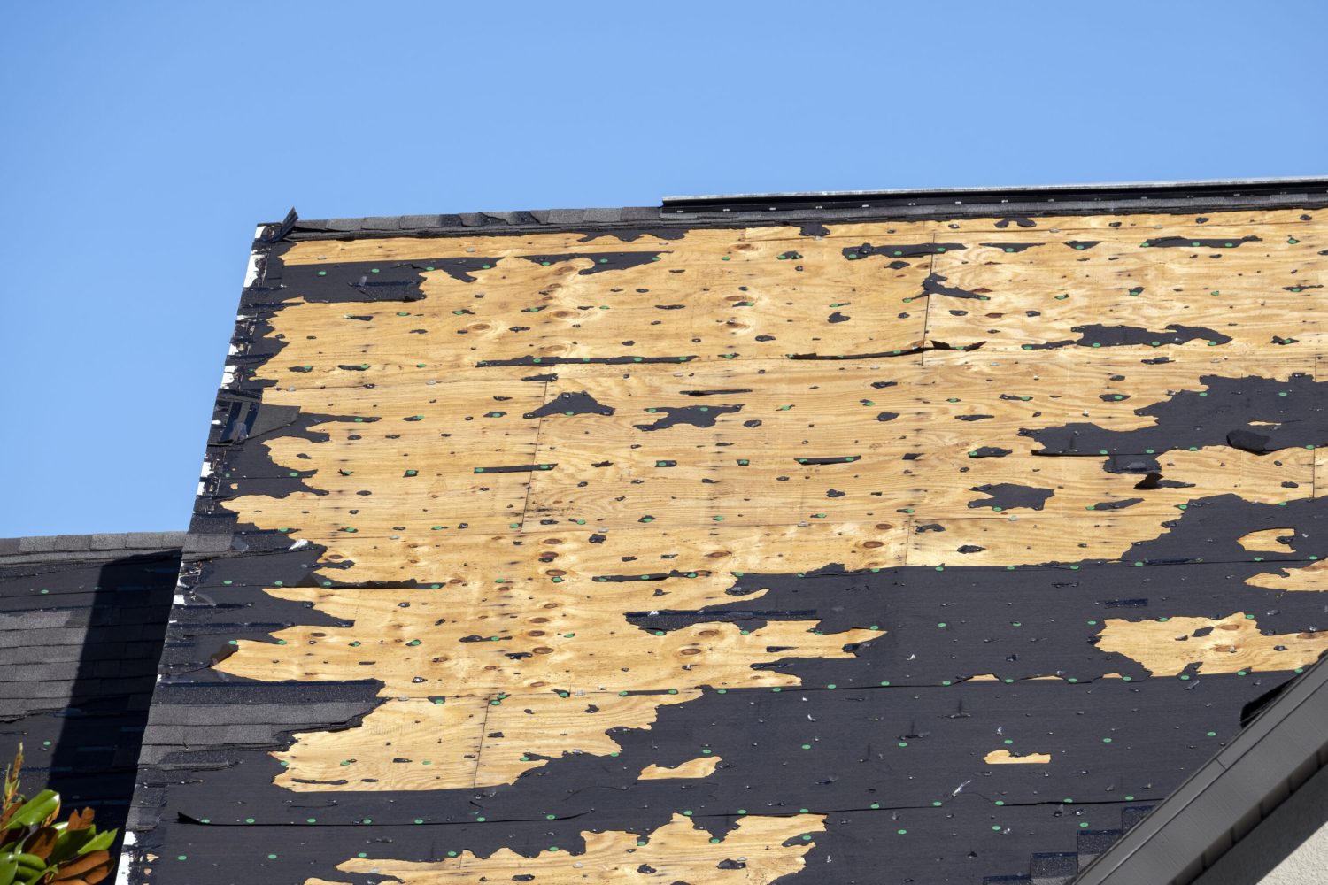 Hurricane Ian destroyed house roof in Florida residential area. Natural disaster and its consequences.