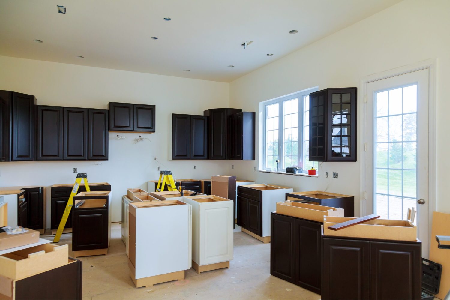 Installing new induction hob in modern kitchen kitchen Installation of kitchen cabinet.